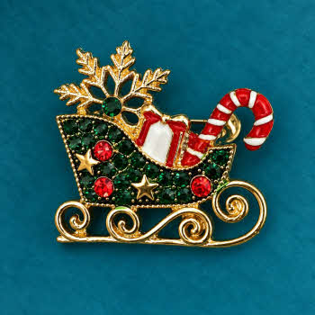 Indulgence Christmas sleigh brooch with red and green stones, present and candy cane