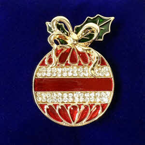 Red and gold Christmas bauble brooch by Indulgence, featuring diamante rows, a gold bow and holly detail presented in a gift box
